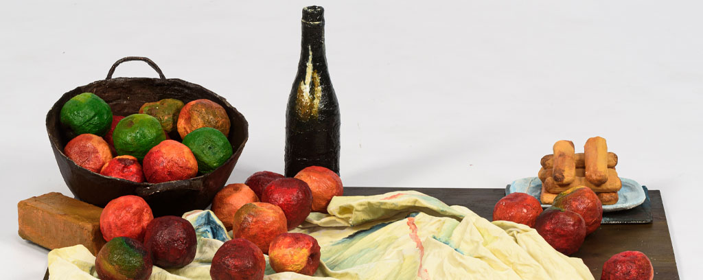 still life painting, apples in a basket and on sheet, jug and plate, sitting on wooden base.